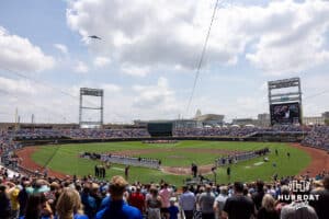 A Stealth Bomber flys over during the singing of National Anthem and boy scouts holding an American flag in the outfield before the start of the College World Series game between Coastal Carolina Chanticleers and Arizona Wildcats on Friday, June 13, 2025 in Omaha, Nebraska. Photo by John S. Peterson.