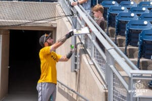 A Louisville player signs autogrpahs during the CWS Media Day on June 12th, 2025 in Omaha, Nebraska. Photo by Brandon Tiedemann.