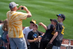 Fans pose for a picture during the CWS Media Day on June 12th, 2025 in Omaha, Nebraska. Photo by Brandon Tiedemann.
