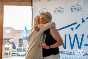 Jacque Tevis-Butler hugs Deb Grafentin during the National Women’s Athletic Leadership Alliance Awards Monday July 21st 2025 in Omaha, Nebraska. Photo by Brandon Tiedemann.