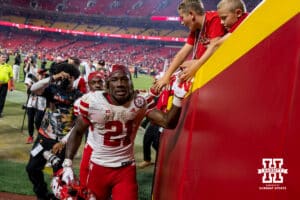 Nebraska Cornhusker Emmett Johnson (21) giving high fives to the fans as he heads to the locker room after the win over the Cincinnati Bearcats during the football game on Thursday, August 28, 2025 in Kansas City, MO. Photo by John S. Peterson.