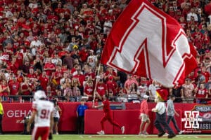 Nebraska Cornhuskers spirit squad member runs the flag along the endzone after the touchdown in the second quarter against the Cincinnati Bearcats during a college football game Thursday, August 28, 2025 in Kansas City, MO. Photo by John S. Peterson.