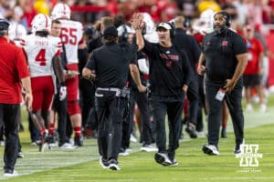 Nebraska Cornhusker coach Mike Ekeler gives Dana Holgorsen a high five celebrating a touchdown at the end of the second quarter against the Cincinnati Bearcats during a college football game on Thursday, August 28, 2025, in Kansas City, MO. Photo by John S. Peterson.