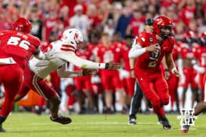 Cincinnati Bearcat quarterback Brendan Sorsby (2) forced out of the pocket as Nebraska Cornhusker Williams Nwaneri (96) reaches for him in the first quarter during a college football game on Thursday, August 28, 2025, in Kansas City, MO. Photo by John S. Peterson.