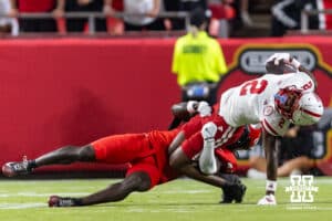 Nebraska Cornhusker Jacory Barney Jr. (2) tackled by Cincinnati Bearcat Jiquan Sanks (9) in the first quarter during a college football game Thursday, August 28, 2025 in Kansas City, MO. Photo by John S. Peterson.
