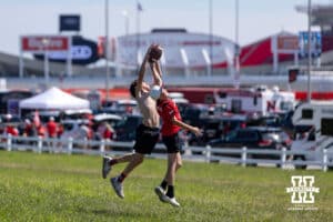 Nebraska Cornhuskers fans playing football in an open field outside of Arrowhead Stadium before the gate opens for the parking lot before a college football game between the Nebraska Cornhuskers and the Cincinnati Bearcats, Thursday, August 28, 2025, in Kansas City, MO. Photo by John S. Peterson.