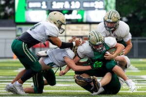 A crew of Central City lineman tackle the ball carrier during a football scrimmage on Friday, August 22, 2025, in Central City, Nebraska. Photo by Braden Cochran.