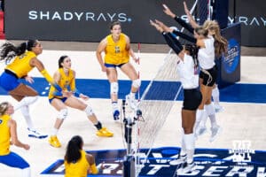Nebraska Cornhusker Andi Jackson (15) blocks a spike by Pittsburgh Panther Olivia Babcock (5) for match point in the fourth set during the AVAC Showcase volleyball match on Friday, Aug. 22, 2025, in Lincoln, Nebraska. Photo by John S. Peterson.