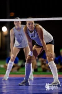 A Millard West player watches from under the net waiting for a serve during the Battle At Buell, Thursday, August 21st, 2025, Millard, Nebraska. Photo by Braden Cochran.