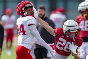 Nebraska Cornhusker Roman Mangini (26) runs with the ball stiff-arms Jordan Ochoa (94) during football practice on Tuesday, Aug. 12, 2025 in Lincoln, Nebraska. Photo by John S. Peterson.