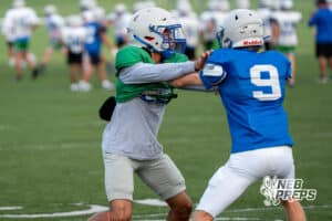 Christin Bolles wraps up a wide reciever during Millard North football practice on Saturday, August 16th, 2025 in Omaha, Nebraska. Photo by Brandon Tiedemann.