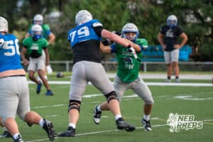 Matt Erickson blocks a defender during Millard North football practice on Saturday, August 16th, 2025 in Omaha, Nebraska. Photo by Brandon Tiedemann.