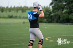 Matt Erickson puts his helmet on during Millard North football practice on Saturday, August 16th, 2025 in Omaha, Nebraska. Photo by Brandon Tiedemann.