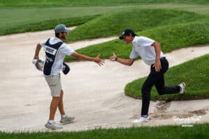 Christo Lamprecht high-fives his caddie, celebrating sinking his final chip shot out of the sand to win during The Pinnacle Bank Championship on August 10th, 2025, in Omaha, Nebraska. Photo by Brandon Tiedemann.