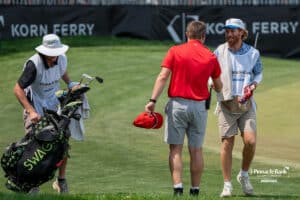 A volunteer shakes a caddies hand during The Pinnacle Bank Championship on August, 10th 2025 in Omaha Nebraska. Photo by Brandon Tiedemann.