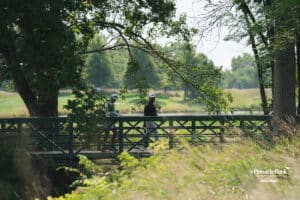 Phichaksn Maichon and his caddy walk across the bridge during the Pinnacle Bank Championship, Sunday, August 10th, 2025, in Omaha, Nebraska. Photo by Nick Barajas.