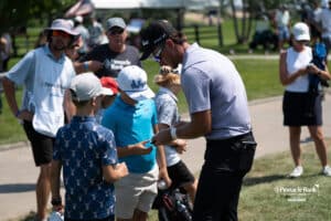 Golfer signs a hat during The Pinnacle Bank Championship on August 8th, 2025, in Omaha, Nebraska. Photo by Brandon Tiedemann.