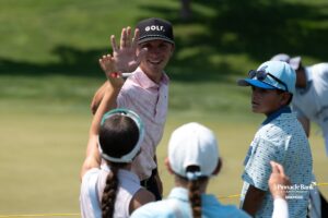 A golfer high-fives fans during The Pinnacle Bank Championship on August 8th, 2025, in Omaha, Nebraska. Photo by Brandon Tiedemann.