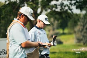 Joe Weiler and his caddy review notes during the Pinnacle Bank Championship golf tournament Thursday, August 7th, 2025, in Omaha, Nebraska. Photo by Nick Barajas.