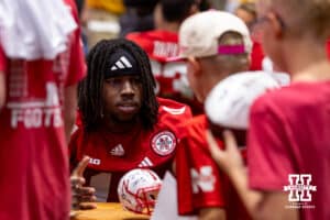 Nebraska Cornhusker Demitrius Bell (11) signs a helmet during Nebraska’s football Fan Day on Saturday, Aug. 2, 2025 in Lincoln, Nebraska. Photo by John S. Peterson.