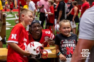 Nebraska Cornhusker Emmett Johnson (21) poses for a photo with a couple young fans during Nebraska’s football Fan Day on Saturday, Aug. 2, 2025 in Lincoln, Nebraska. Photo by John S. Peterson.