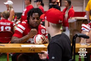 Nebraska Cornhusker Jamarion Parker (24) signs a helmet for a young fan during Nebraska’s football Fan Day on Saturday, Aug. 2, 2025 in Lincoln, Nebraska. Photo by John S. Peterson.