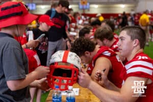 Nebraska Cornhusker Shawn Hammerbeck (79) signs a helmet for a fan during Nebraska’s football Fan Day on Saturday, Aug. 2, 2025 in Lincoln, Nebraska. Photo by John S. Peterson.