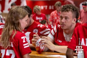 Nebraska Cornhusker Tyler Knaak (75) signs a small helmet for a young fan during Nebraska’s football Fan Day on Saturday, Aug. 2, 2025 in Lincoln, Nebraska. Photo by John S. Peterson.