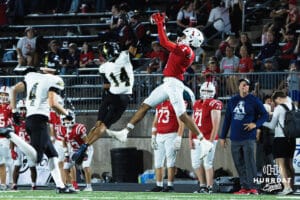 Amarion Jackson catches the ball over the defender during the Millard South football game vs Lincoln Southeast on September 25th, 2025 in Omaha, Nebraska. Photo by Drew Balus