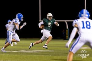 Gretna quarterback Michael Knudsen (5) breaks to the sideline to evade Bennington defenders during a High School Football game, Friday, September 26th, 2025, Gretna, Nebraska. Photo by Braden Cochran.