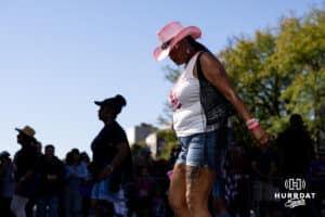 A lady dances with a dance group with fans during the Terence "Bud" Crawford World Champion Victory Parade, Saturday, September 27, 2025, Omaha, Nebraska. Photo by Braden Cochran.
