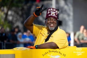 A Shriner gestures to the crowd while driving down the route during the Terence "Bud" Crawford World Champion Victory Parade, Saturday, September 27, 2025, Omaha, Nebraska. Photo by Braden Cochran.