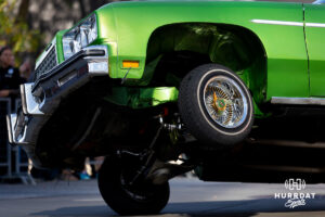 A lowrider drives on three wheels to give the crowd a show during the Terence "Bud" Crawford World Champion Victory Parade, Saturday, September 27, 2025, Omaha, Nebraska. Photo by Braden Cochran.