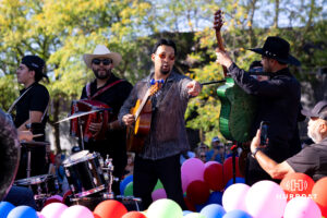 A guitarist with Rosendo Robel interacts with the fans during the Terence "Bud" Crawford World Champion Victory Parade, Saturday, September 27, 2025, Omaha, Nebraska. Photo by Braden Cochran.