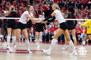 Nebraska Cornhusker middle blocker Andi Jackson (15) celebrates a kill with setter Bergen Reilly (2) against the Maryland Terrapins in the third set during a college volleyball match on Saturday, September 27, 2025, in Lincoln, Nebraska. Photo by John S. Peterson.