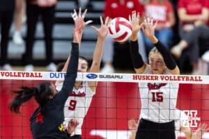 Nebraska Cornhusker middle blocker Andi Jackson (15) with opposite Virginia Adriano (9) blocks the ball against Maryland Terrapin outside hitter Haley Melby (4) during a college volleyball match on Saturday, September 27, 2025, in Lincoln, Nebraska. Photo by John S. Peterson.