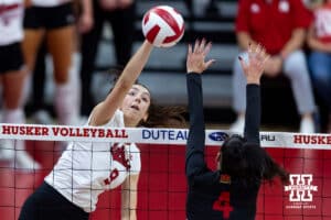 Nebraska Cornhusker opposite Virginia Adriano (9) spikes the ball against the Maryland Terrapin outside hitter Haley Melby (4) in the second set during a college volleyball match on Saturday, September 27, 2025, in Lincoln, Nebraska. Photo by John S. Peterson.