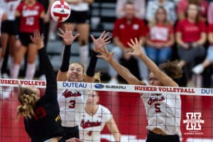 Nebraska Cornhusker opposite Allie Sczech (3) and middle blocker Rebekah Allick (5) jump up to block Maryland Terrapin outside hitter Olivia Ruy (19) in the second set during a college volleyball match on Saturday, September 27, 2025, in Lincoln, Nebraska. Photo by John S. Peterson.