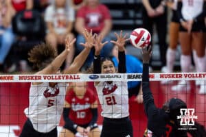 Nebraska Cornhusker middle blocker Rebekah Allick (5) and outside hitter Skyler Pierce (21) blocks the ball against Maryland Terrapin outside hitter Ajack Malual (3) in the first set during a college volleyball match on Saturday, September 27, 2025, in Lincoln, Nebraska. Photo by John S. Peterson.