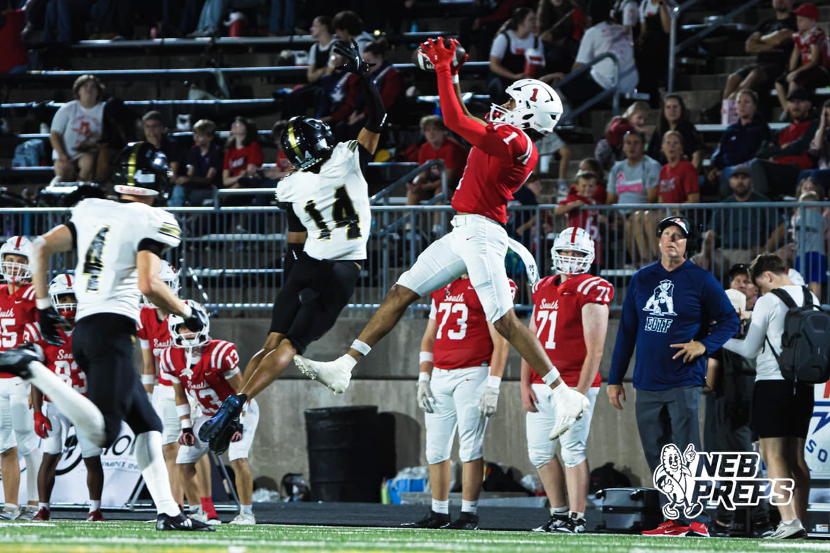 Amarion Jackson catches the ball over the defender during the Millard South football game vs Lincoln Southeast on September 25th, 2025 in Omaha, Nebraska. Photo by Drew Balus