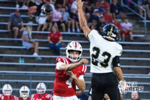 Jett Thomalla throws past the defender during the Millard South football game vs Lincoln Southeast on September 25th, 2025, in Omaha, Nebraska. Photo by Drew Balus.