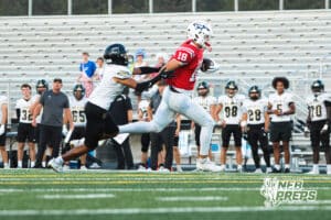Isaac Jensen pushes off the defender during the Millard South football game vs Lincoln Southeast on September 25th, 2025, in Omaha, Nebraska. Photo by Drew Balus.
