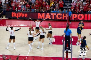 The Nebraska Cornhuskers celebrate the sweep against the Michigan Wolverines during a college volleyball match on Wednesday, September 24, 2025, in Lincoln, Nebraska. Photo by John S. Peterson.