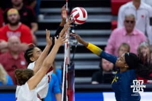 Nebraska Cornhusker Taylor Landfair (12) blocks the ball against Michigan Wolverine middle blocker Serena Nyambio (1) in the third set during a college volleyball match on Wednesday, September 24, 2025, in Lincoln, Nebraska. Photo by John S. Peterson.