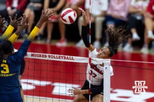Nebraska Cornhusker Harper Murray (27) spikes the ball against Michigan Wolverine Cymarah Gordon (3) in the second set during a college volleyball match on Wednesday, September 24, 2025, in Lincoln, Nebraska. Photo by John S. Peterson.