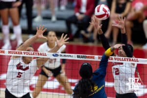 Nebraska Cornhusker Taylor Landfair (12) blocks a spike against the Michigan Wolverines in the second set during a college volleyball match on Wednesday, September 24, 2025, in Lincoln, Nebraska. Photo by John S. Peterson.