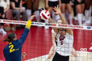 Nebraska Cornhusker Rebekah Allick (5) blocks the ball against Michigan Wolverine outside hitter Allison Jacobs (2) in the second set during a college volleyball match on Wednesday, September 24, 2025, in Lincoln, Nebraska. Photo by John S. Peterson.