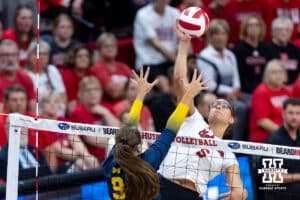 Nebraska Cornhusker Rebekah Allick (5) spikes the ball against Michigan Wolverine outside hitter Ella Demetrician (9) in the second set during a college volleyball match on Wednesday, September 24, 2025, in Lincoln, Nebraska. Photo by John S. Peterson.