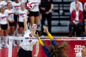 Nebraska Cornhusker Virginia Adriano (9) spikes the ball against the Michigan Wolverines in the second set during a college volleyball match on Wednesday, September 24, 2025, in Lincoln, Nebraska. Photo by John S. Peterson.