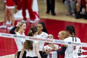 The Nebraska Cornhuskers celebrate taking the first set against the Michigan Wolverines during a college volleyball match on Wednesday, September 24, 2025, in Lincoln, Nebraska. Photo by John S. Peterson.
